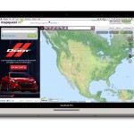 Website showing a racing car and a map of North America on a laptop screen.