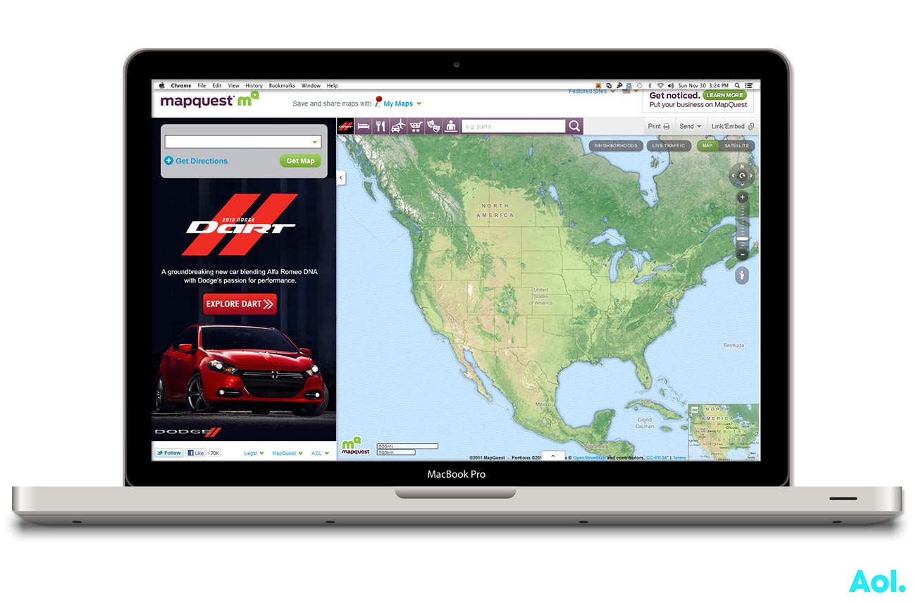 Website showing a racing car and a map of North America on a laptop screen.